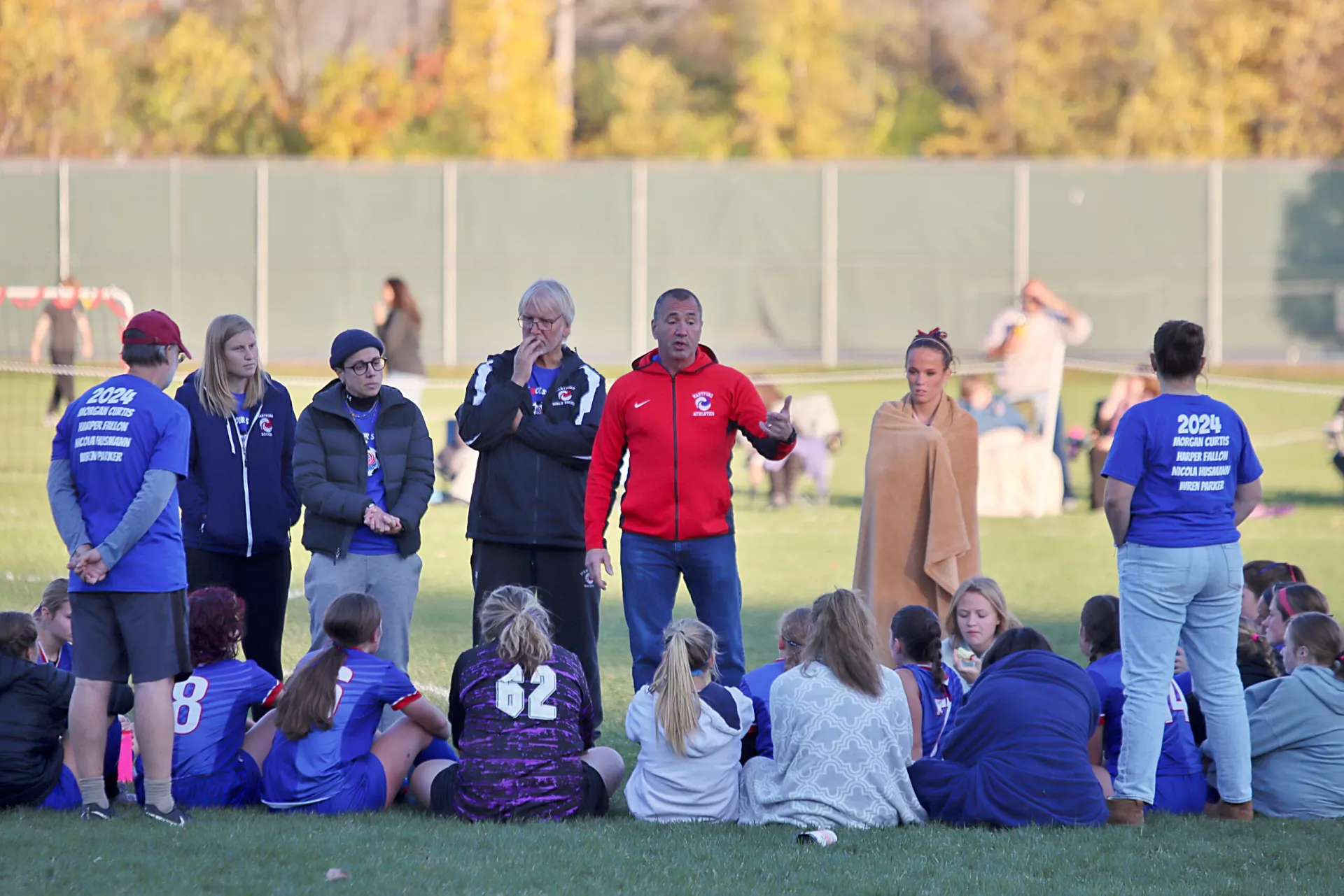 Coach Joe standing with his team before a game