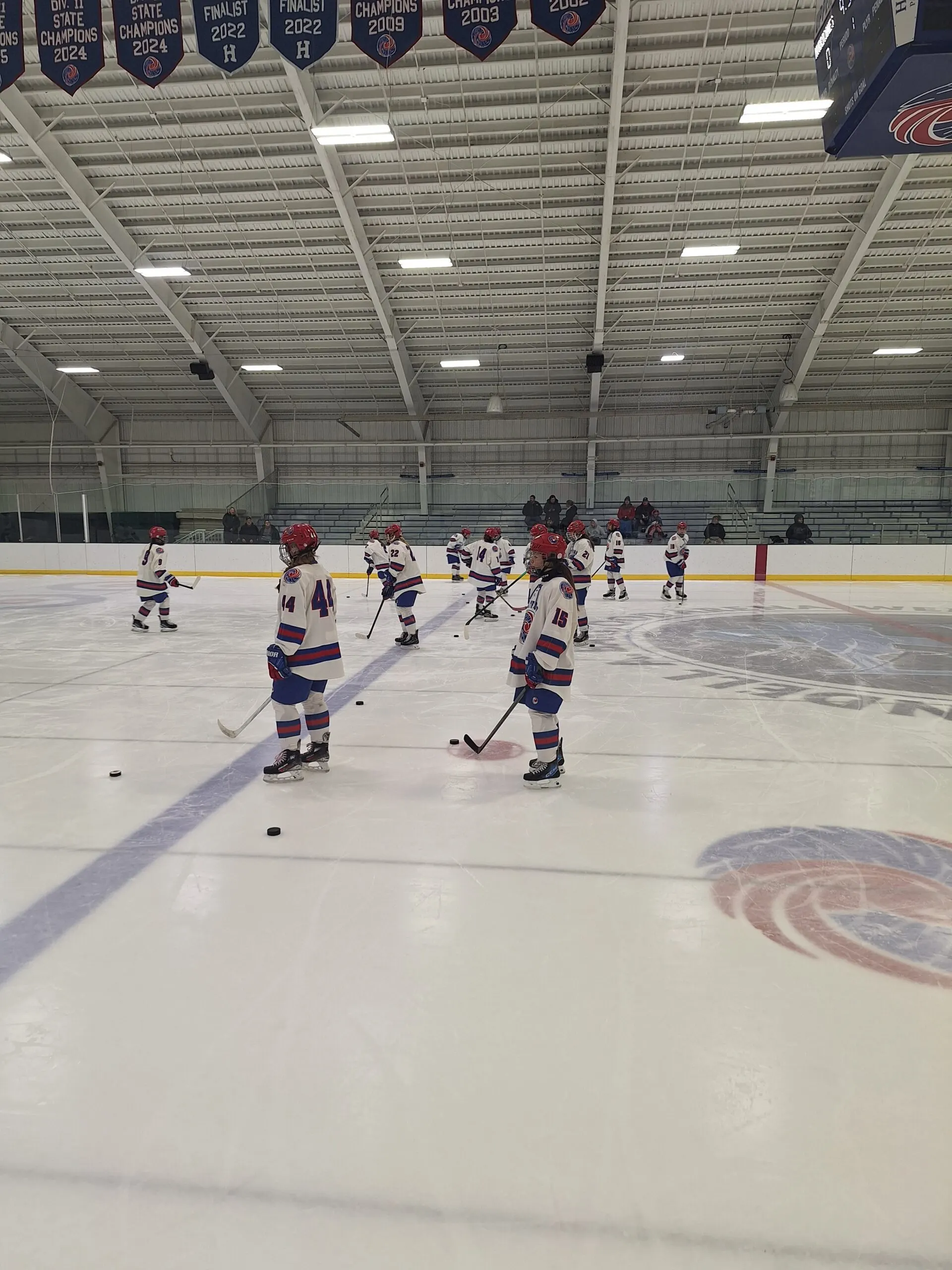 Coach Joe overseeing athletes on the hockey rink