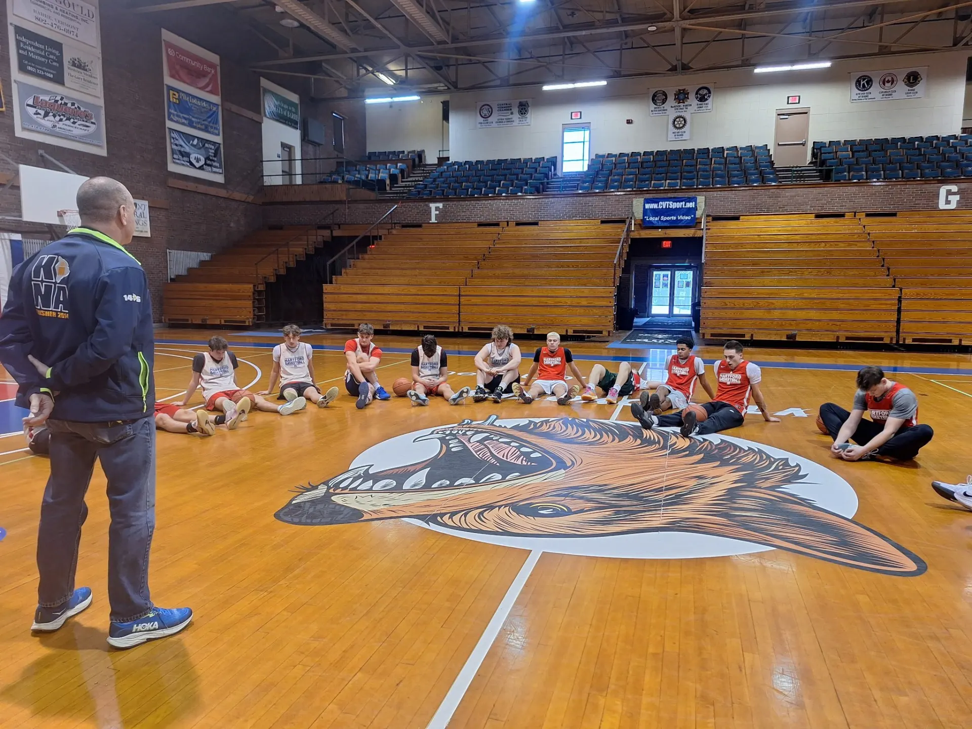 Coach Joe reviewing strategy with an athlete